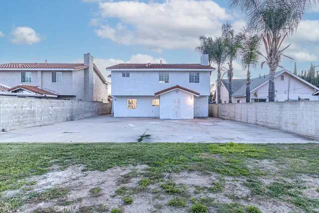 a front view of house with a garden