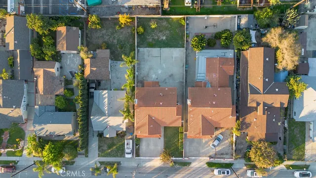 an aerial view of multiple houses with a yard