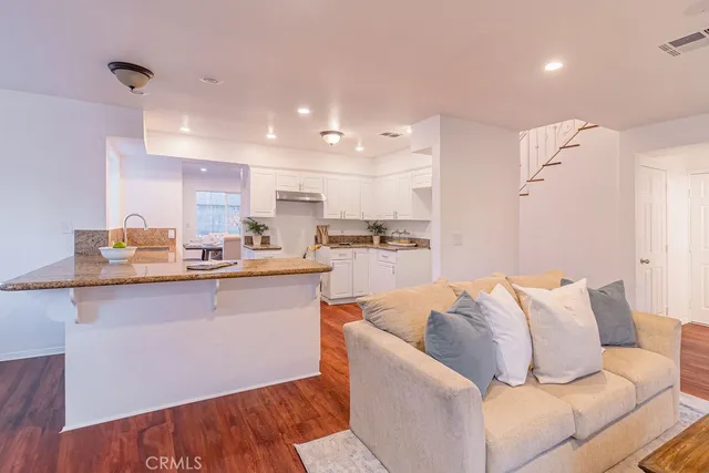 a living room with furniture and kitchen view