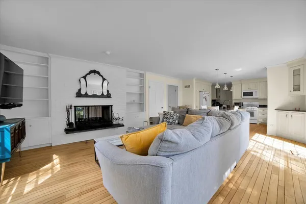 a living room with furniture a fireplace and a flat screen tv