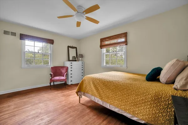 a bedroom with a bed couch and window