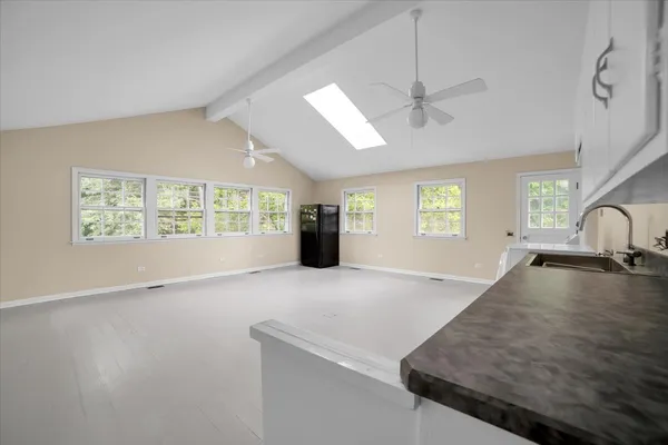 a view of a kitchen with a sink cabinets and a window