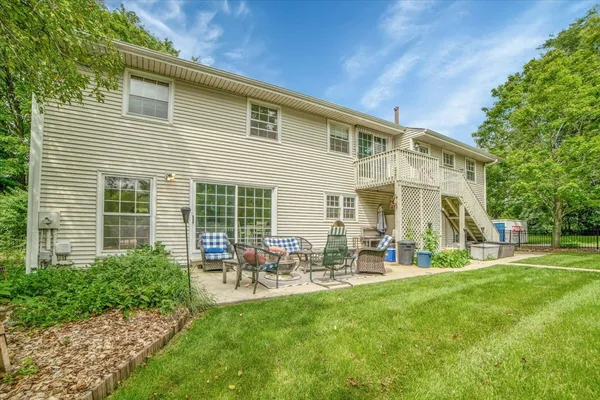 a view of a house with backyard and sitting area