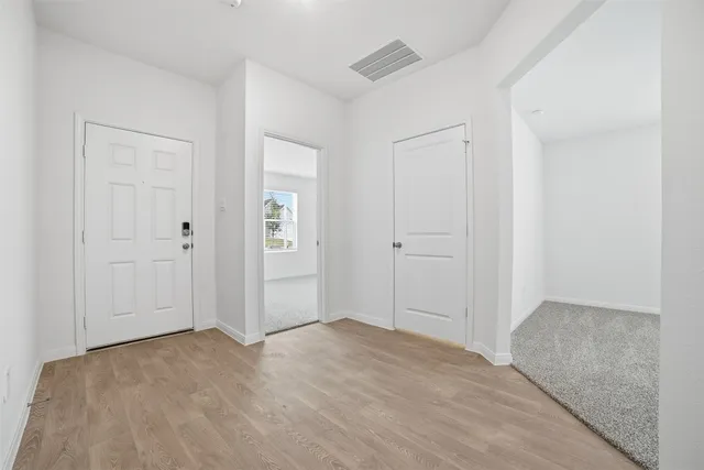 a view of kitchen with kitchen island stainless steel appliances cabinets and a window