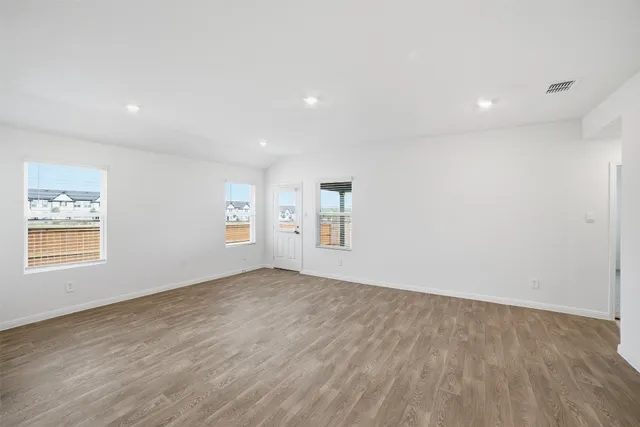 a view of kitchen with kitchen island white cabinets and stainless steel appliances
