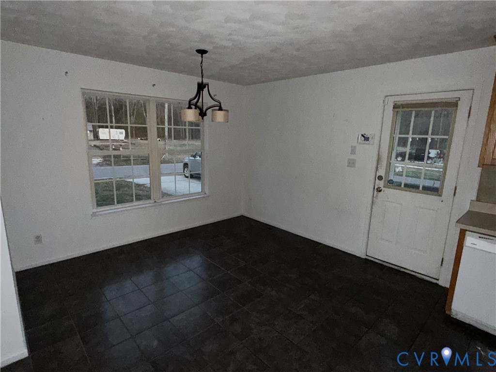 117 Pleasant Spring Avenue Waverly, VA 23890 - Photo 3 of 12 a view of an empty room with a kitchen