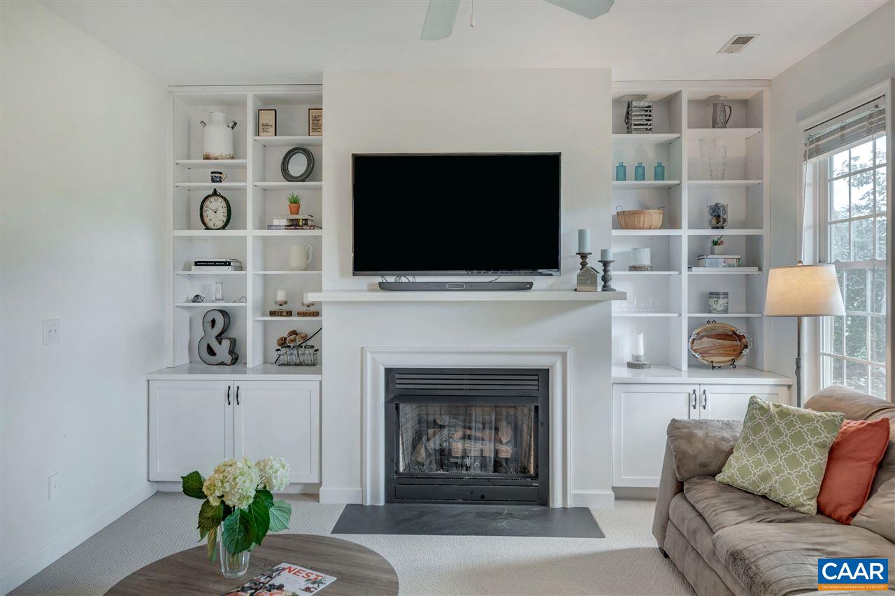 1345 Amber Ridge Road Charlottesville, VA 22901 - Photo 11 of 34 a living room with furniture a flat screen tv and a fireplace