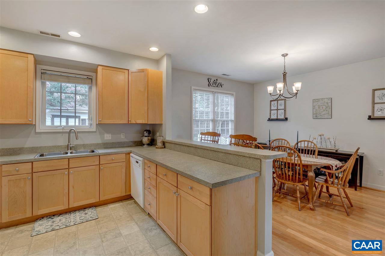 1345 Amber Ridge Road Charlottesville, VA 22901 - Photo 14 of 34 a kitchen with center island table and chairs in it