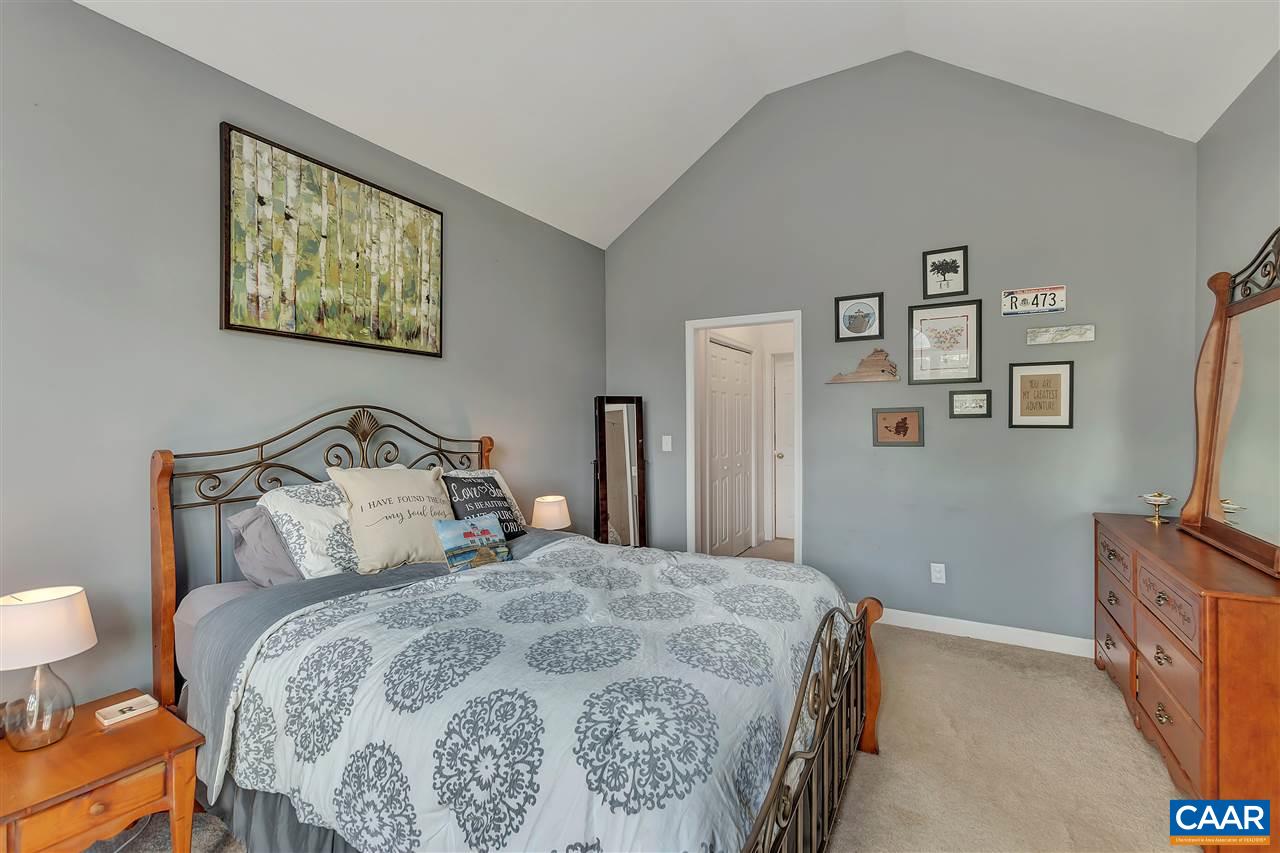 1345 Amber Ridge Road Charlottesville, VA 22901 - Photo 22 of 34 a bedroom with a bed and a flat screen tv
