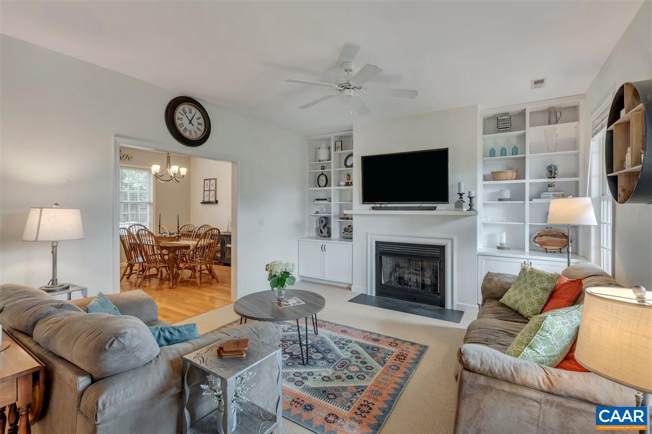 1345 Amber Ridge Road Charlottesville, VA 22901 - Photo 10 of 34 a living room with furniture a fireplace and a flat screen tv