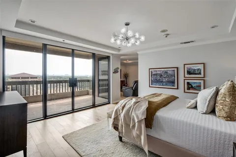 a bedroom with a large bed and a chandelier