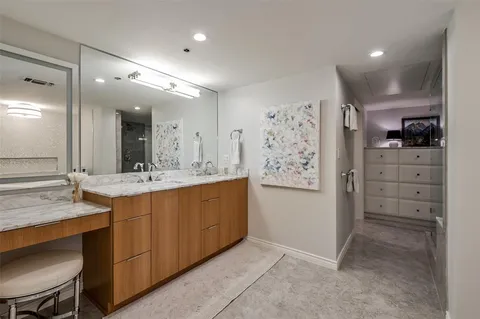 a bathroom with a double vanity sink mirror and shower