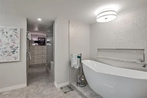 a bathroom with a bathtub and a shower