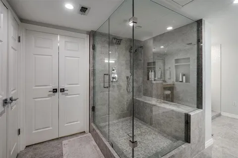a bathroom with a shower and a glass door