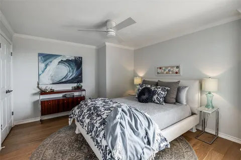 a bedroom with bed and a chandelier