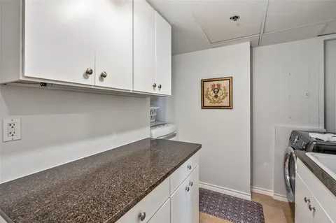 a kitchen with granite countertop a sink and a stove