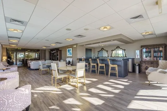 a living room with lots of furniture and a book shelf