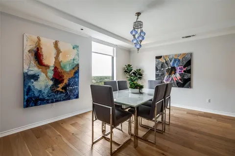 a view of a dining room with furniture wooden floor and a chandelier