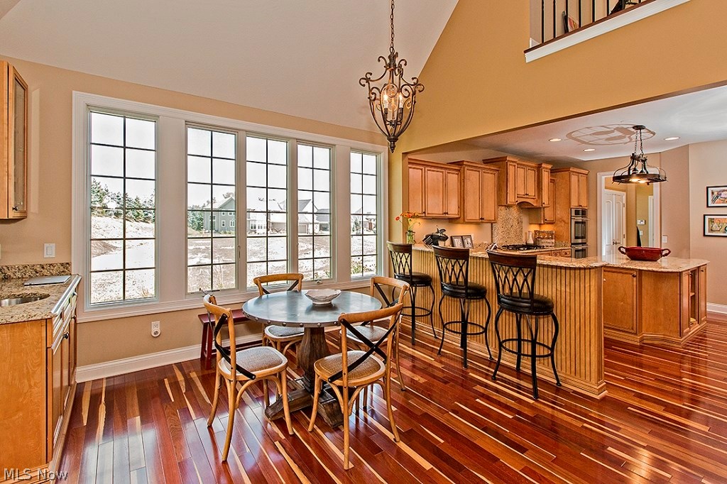 3375 Legends Way Cleveland, OH 44124 - Photo 13 of 33 Dinette Area with Custom Built-in Cabinetry with wet Bar and Granite Counter Top, and Sliding Glass Doors Leading to the Patio