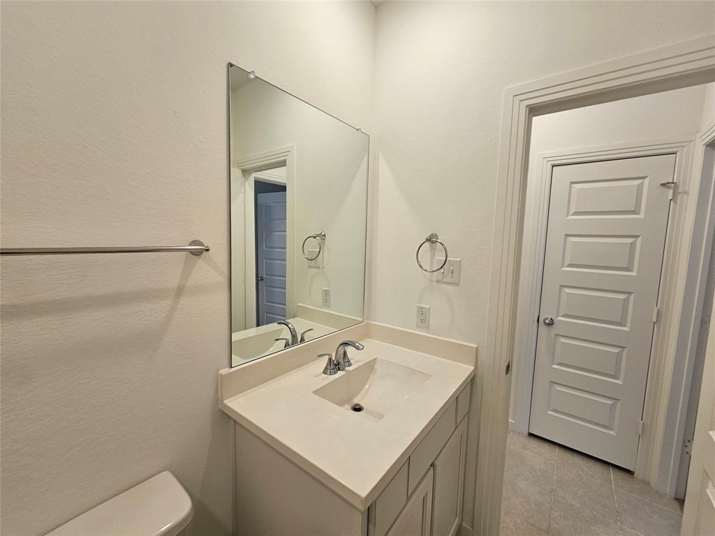 3915 Chesapeake Lane Crandall, TX 75114 - Photo 17 of 32 a bathroom with a sink toilet and vanity