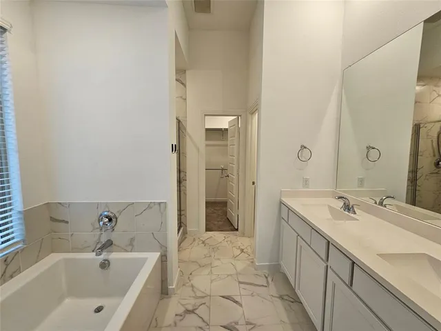 a bathroom with a granite countertop shower and a toilet