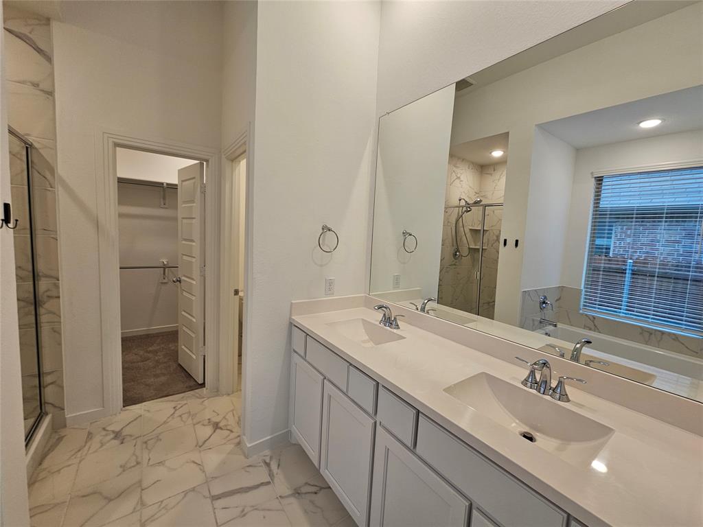 3915 Chesapeake Lane Crandall, TX 75114 - Photo 23 of 32 a spacious bathroom with a sink and a mirror