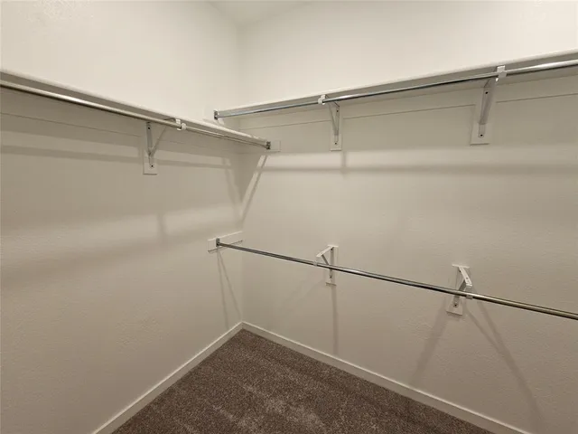 a side view of a house with a wooden fence