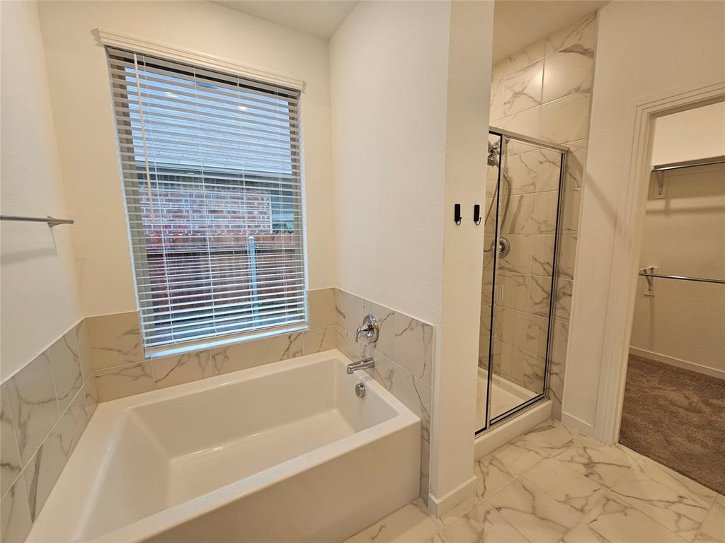 3915 Chesapeake Lane Crandall, TX 75114 - Photo 25 of 32 a bathroom with a bathtub and a shower