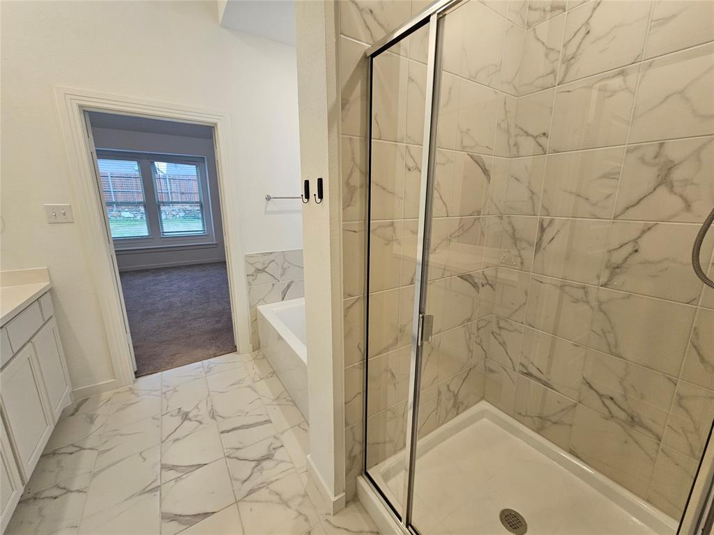3915 Chesapeake Lane Crandall, TX 75114 - Photo 26 of 32 a bathroom with a bathtub and a shower
