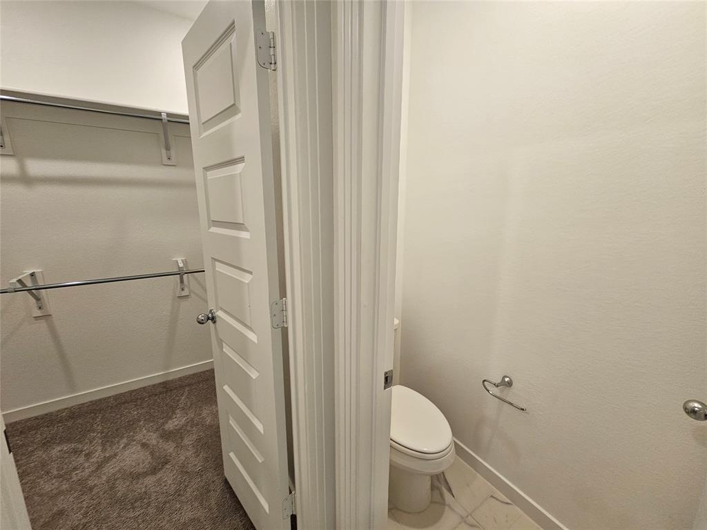 3915 Chesapeake Lane Crandall, TX 75114 - Photo 27 of 32 a bathroom with a granite countertop shower and a toilet
