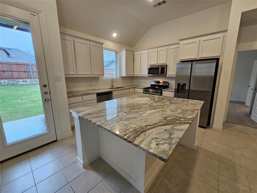 3915 Chesapeake Lane Crandall, TX 75114 - Photo 3 of 32 a kitchen with sink refrigerator and microwave