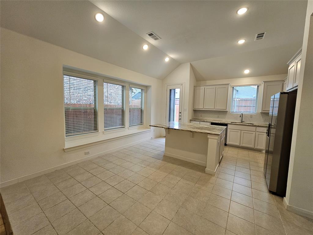 3915 Chesapeake Lane Crandall, TX 75114 - Photo 7 of 32 a large white kitchen with a refrigerator a stove a sink and a cabinets