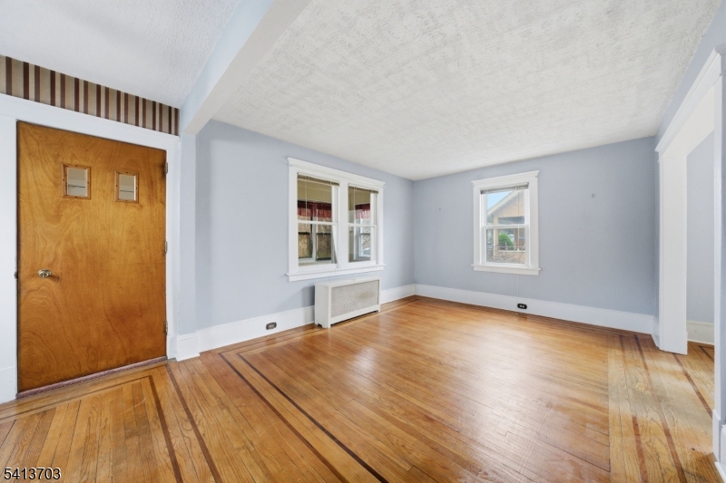 149 Roessler Street Boonton, NJ 07005 - Photo 11 of 42 an empty room with wooden floor and windows