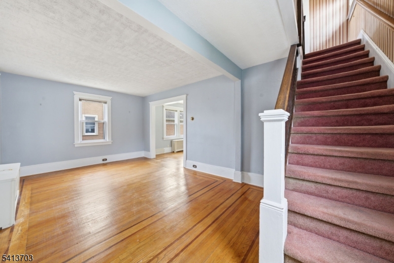 149 Roessler Street Boonton, NJ 07005 - Photo 13 of 42 a view of an empty room with wooden floor and a window