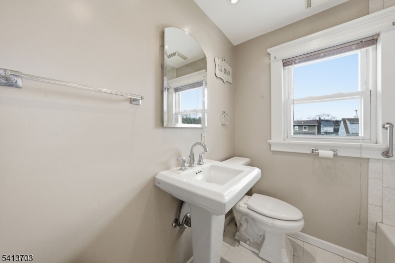 149 Roessler Street Boonton, NJ 07005 - Photo 17 of 42 a bathroom with a sink mirror and toilet