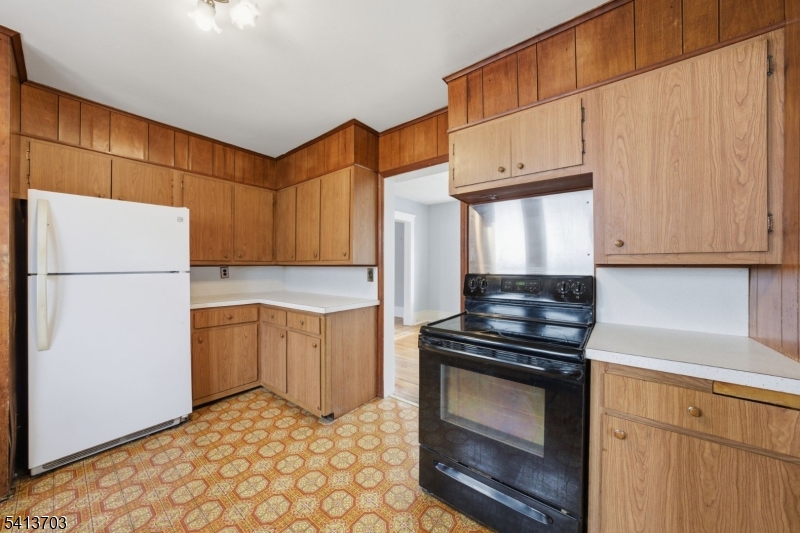 149 Roessler Street Boonton, NJ 07005 - Photo 7 of 42 a kitchen with a stove a refrigerator and cabinets