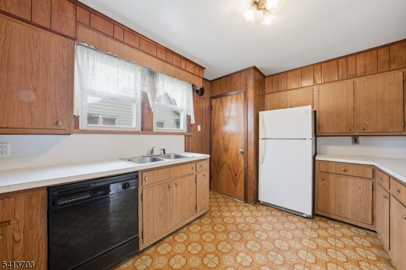 149 Roessler Street Boonton, NJ 07005 - Photo 8 of 42 a kitchen with a sink a refrigerator and cabinets