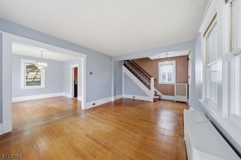 149 Roessler Street Boonton, NJ 07005 - Photo 10 of 42 a view of an empty room with wooden floor and stairs