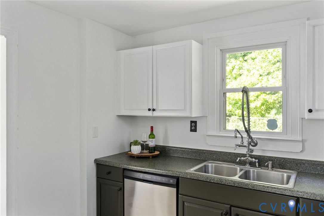 200 Brooks Road Richmond, VA 23223 - Photo 21 of 58 a kitchen with granite countertop a sink window and cabinets