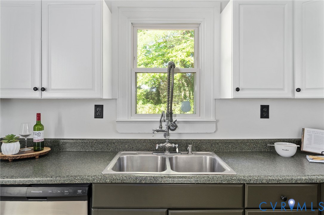 200 Brooks Road Richmond, VA 23223 - Photo 26 of 58 a kitchen with granite countertop a sink a stove and cabinets
