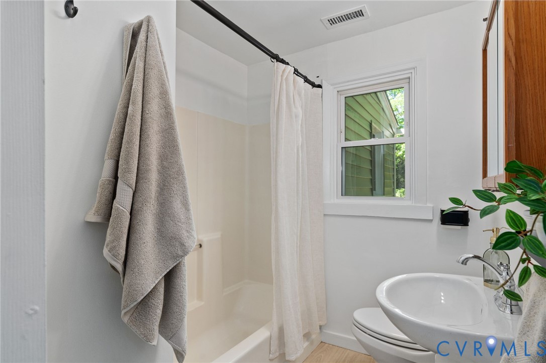 200 Brooks Road Richmond, VA 23223 - Photo 33 of 58 a bathroom with a sink a window and a shower