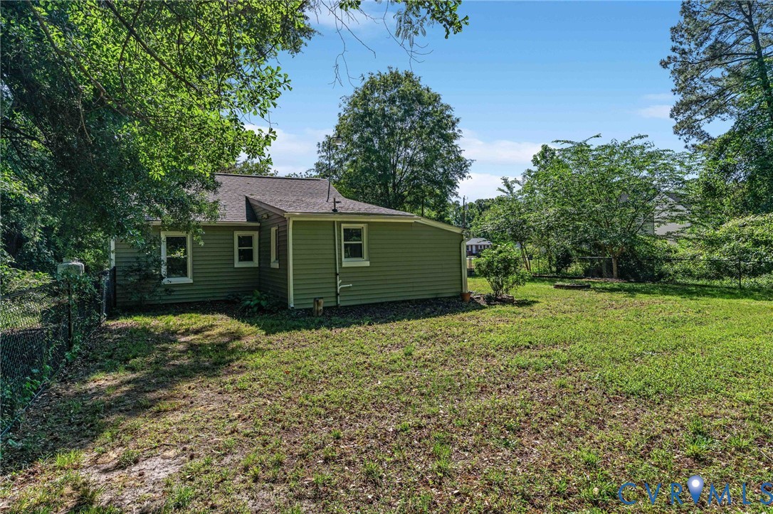 200 Brooks Road Richmond, VA 23223 - Photo 51 of 58 a backyard of a house with large trees and plants