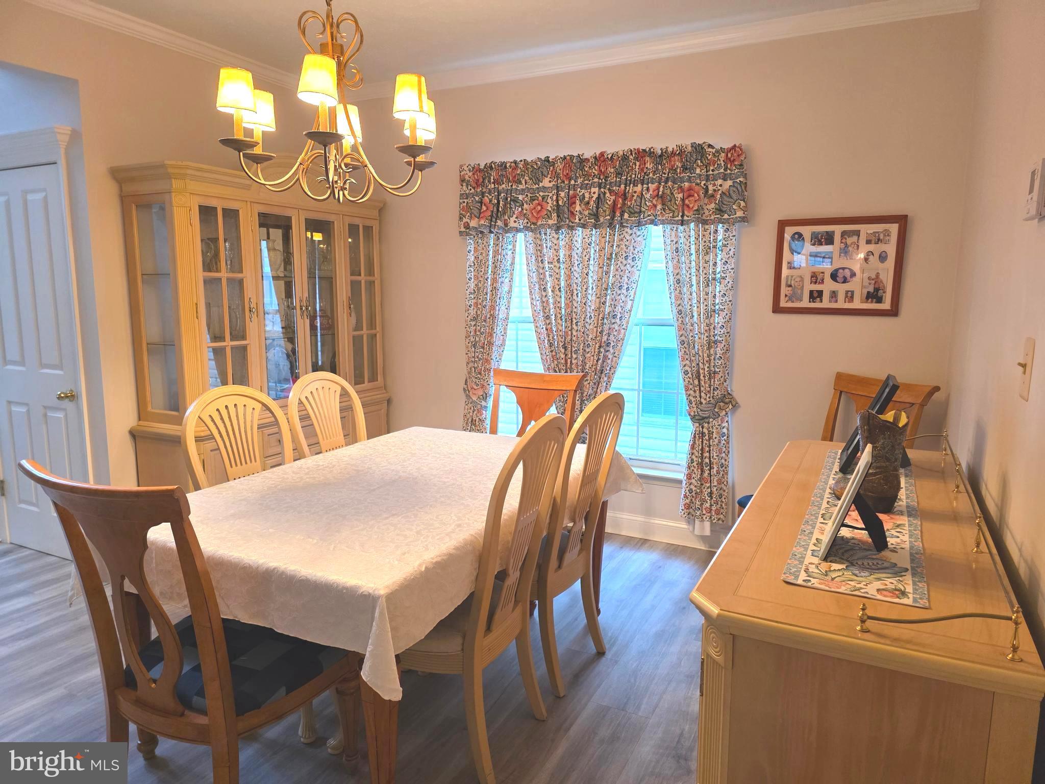 2441 Kemper Road Crofton, MD 21114 - Photo 10 of 63 a view of a dining room with furniture wooden floor and chandelier