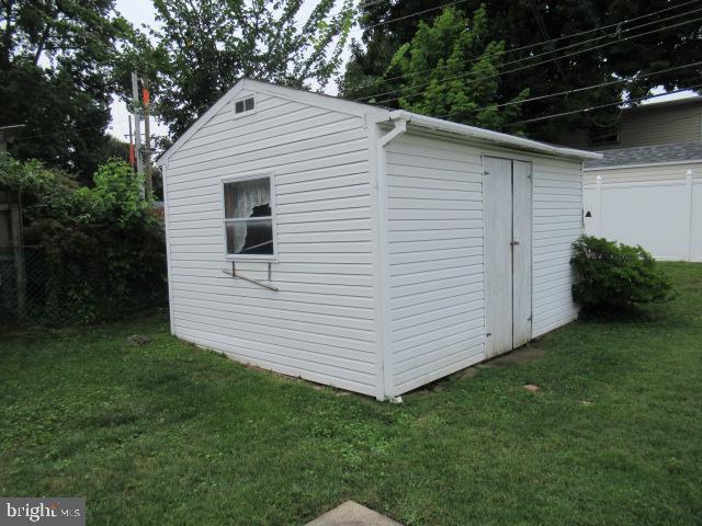 45 Queens Bridge Road Levittown, PA 19057 - Photo 7 of 18 Charming white shed in a lush yard.