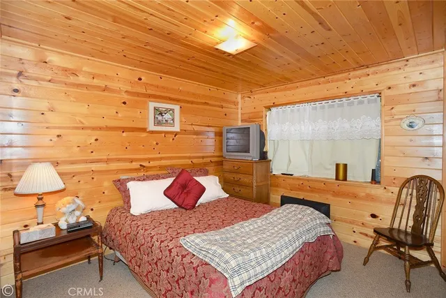 a bedroom with a bed and a night stand