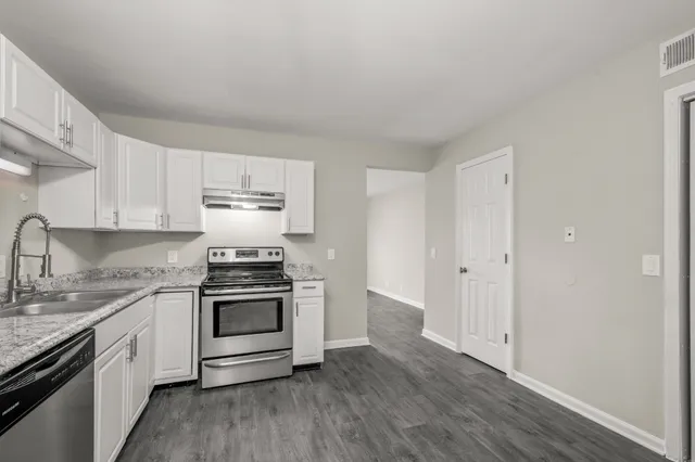 a kitchen with stainless steel appliances granite countertop a stove and a sink