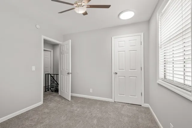 an empty room with windows and closet