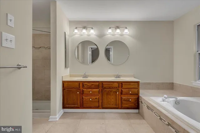 a bathroom with a double vanity sink and a bathtub