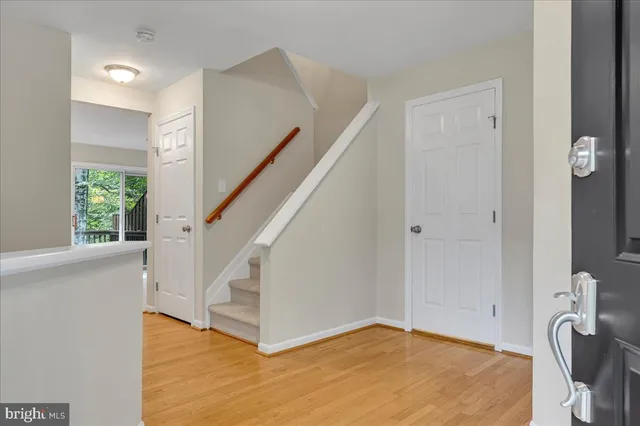 a view of a livingroom with wooden floor and staircase