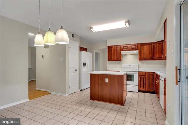 a kitchen with stainless steel appliances a refrigerator and a stove